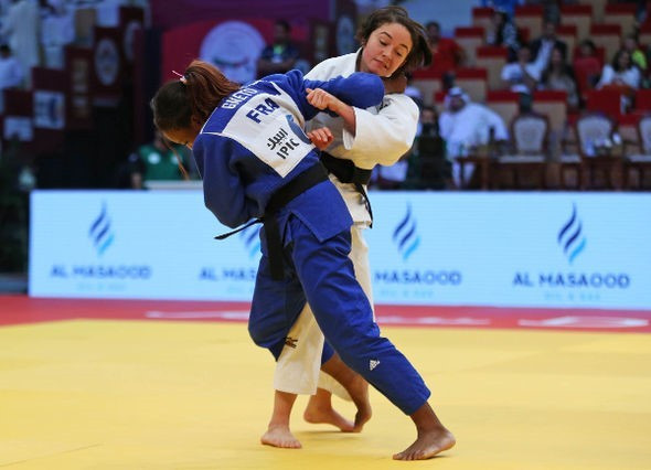 Astride Gneto, in blue, was the first French athlete to take gold, as she was successful in under 52 kilogram competition ©IJF