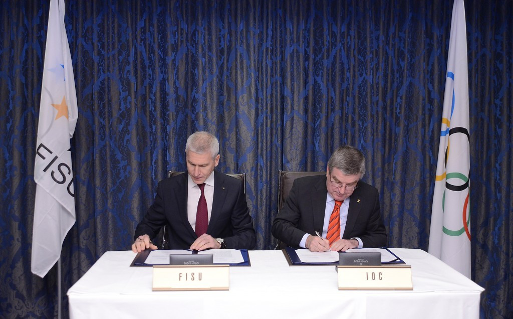 FISU President Oleg Matytsin (left) signs the agreement alongside Thomas Bach ©FISU