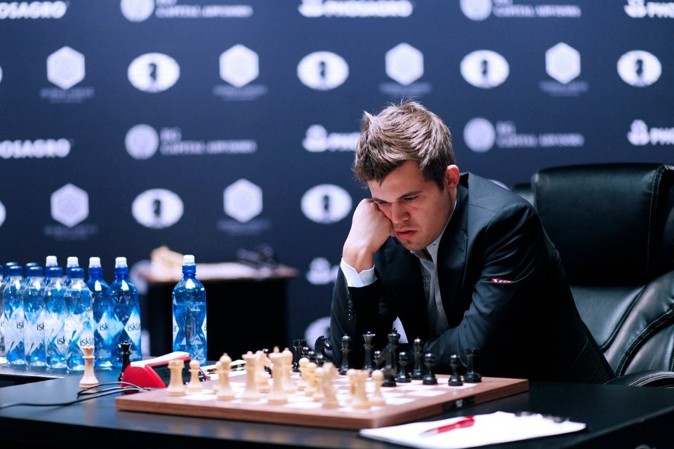 World champion Magnus Carlsen ponders a move in game seven ©FIDE