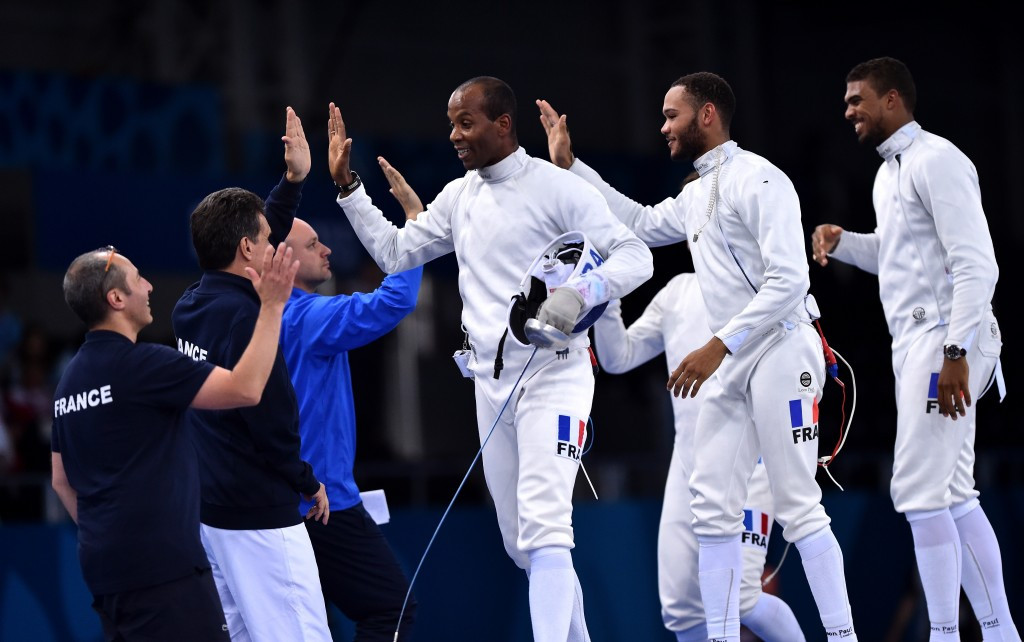 France's 43-year-old double fencing gold medallist Ivan Trevejo celebrates team gold (centre) ©Getty Images