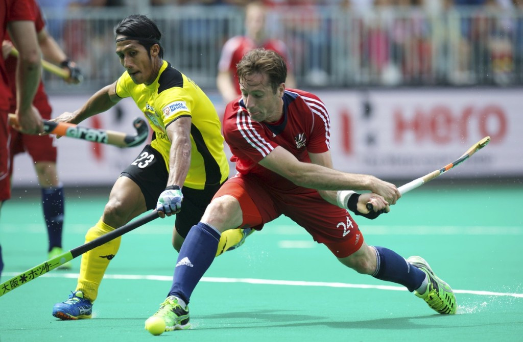 Britain came from behind to beat Malaysia and secure second position in Pool B