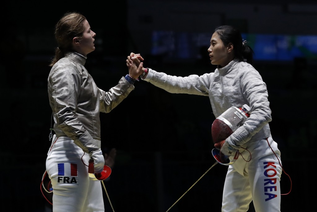 South Korea's Kim Jiyeon, right, seen here shaking hands with French fencer Cecilia Berder at Rio 2016, is the second highest ranked fighter at the tournament ©Getty Images