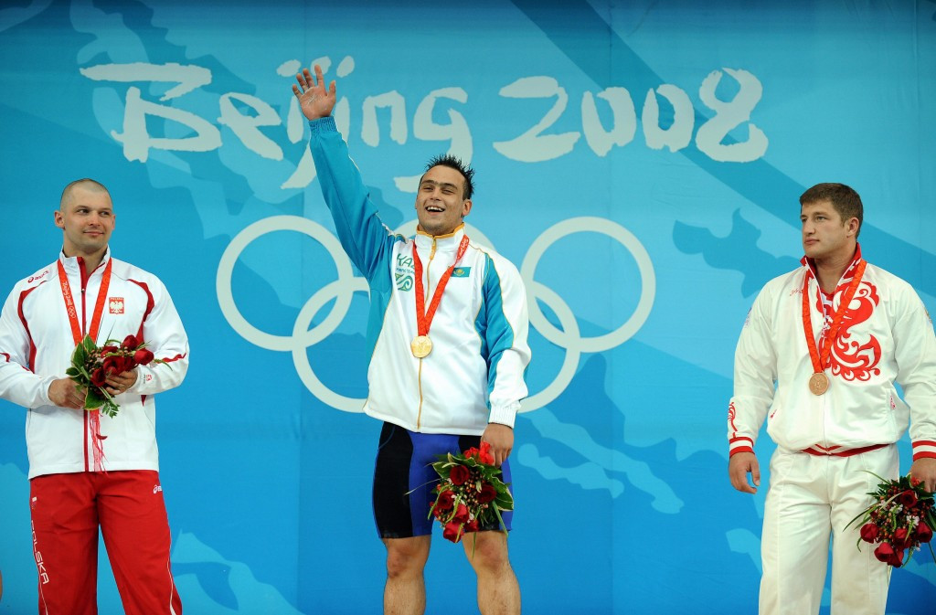 Szymon Kolecki stands to receive the medal after Kazakhstan's Ilya Ilyin was stripped of his gold in November ©Getty Images