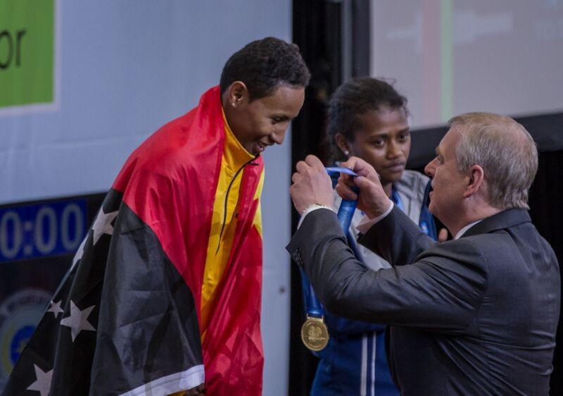 Papua New Guinea's Thelma Mea Toua received her three gold medals from Duke of York Prince Andrew ©Port Moresby 2015