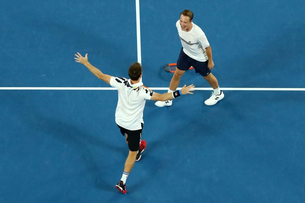 Henri Kontinen of Finland and John Peers of Australia celebrate their mixed doubles victory ©Getty Images