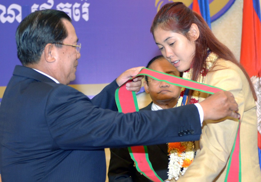 Hun Sen, left, pictured honouring taekwondo player Sorn Seavmey after she claimed Cambodia's first ever Asian Games gold medal at Incheon 2014 ©Getty Images