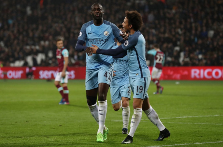 Yaya Toure, left, is congratulated by Leroy Sane after putting Manchester City 4-0 up at West Ham through a 67th minute penalty. Time to leave for some West Ham fans. Why? ©Getty Images