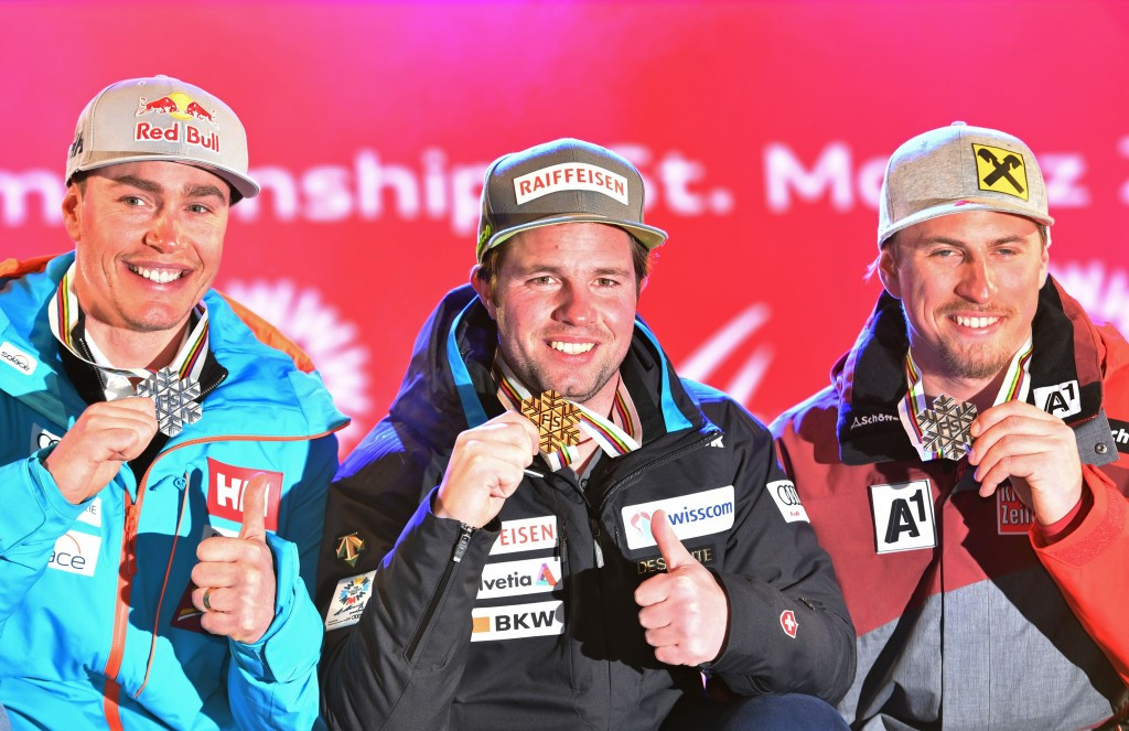 Beat Feuz, centre, celebrates his World Championship victory ©Getty Images