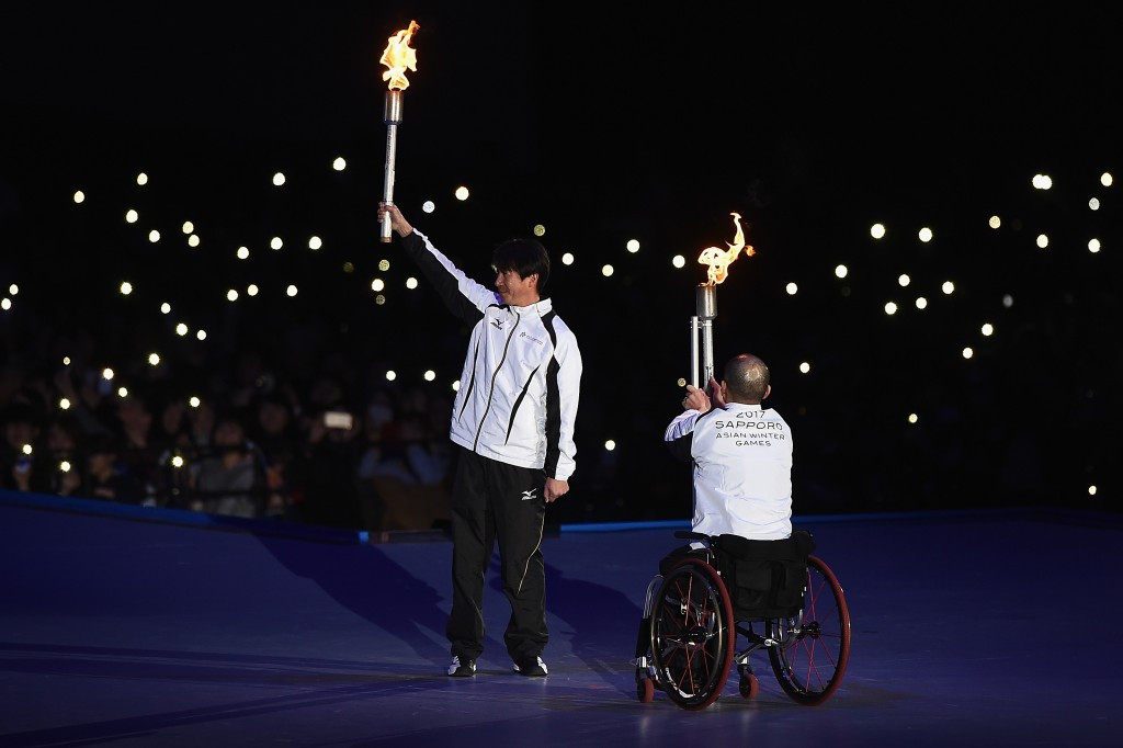 Ski jumper Masahiko Harada, left, received the Torch in order to light the Winter Asian Games flame ©Getty Images