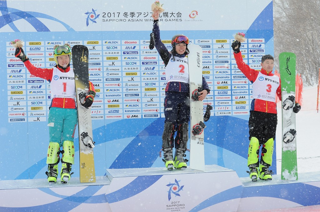 Snowboarder Eri Yanetani of Japan, centre, celebrates winning the first gold medal of Sapporo 2017 ©Getty Images