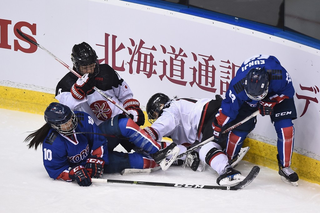 Ice hockey players clash for the puck in a women's game between South Korea and Japan ©Getty Images