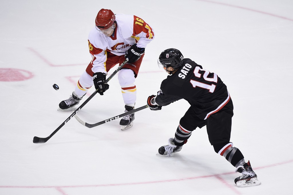 Japanese and Chinese ice hockey players battle for confrol of the puck ©Getty Images