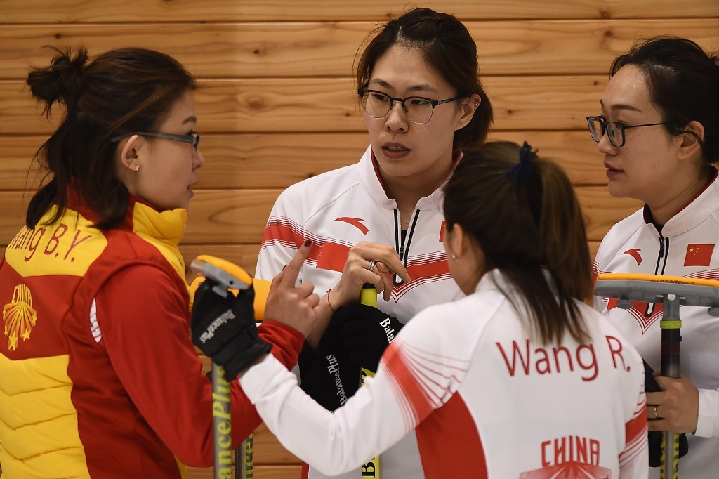 China's curling team have a tactical discussion with their coach ©Getty Images