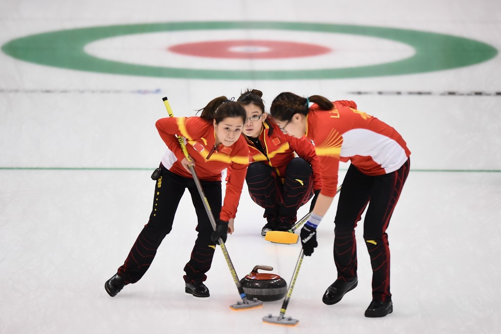 China sweep the ice during their victory over South Korea ©Getty Images