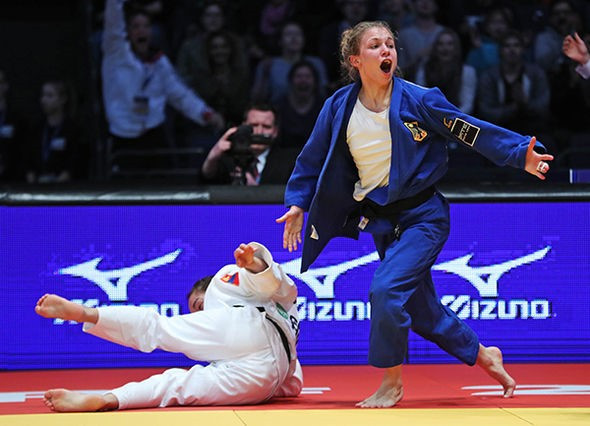 Germany's Theresa Stoll, blue, delighted the home fans by taking a surprising gold medal today ©IJF