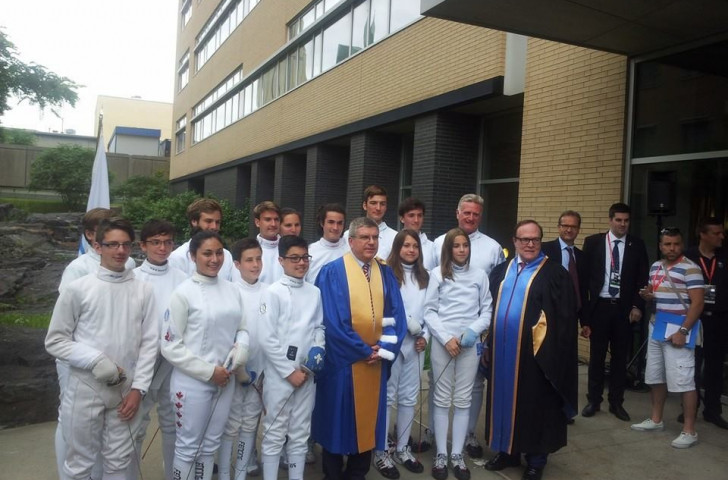 Thomas Bach and Marcel Aubut (right) pose with young fencers following a graduation ceremony at the University of Montreal ©ITG
