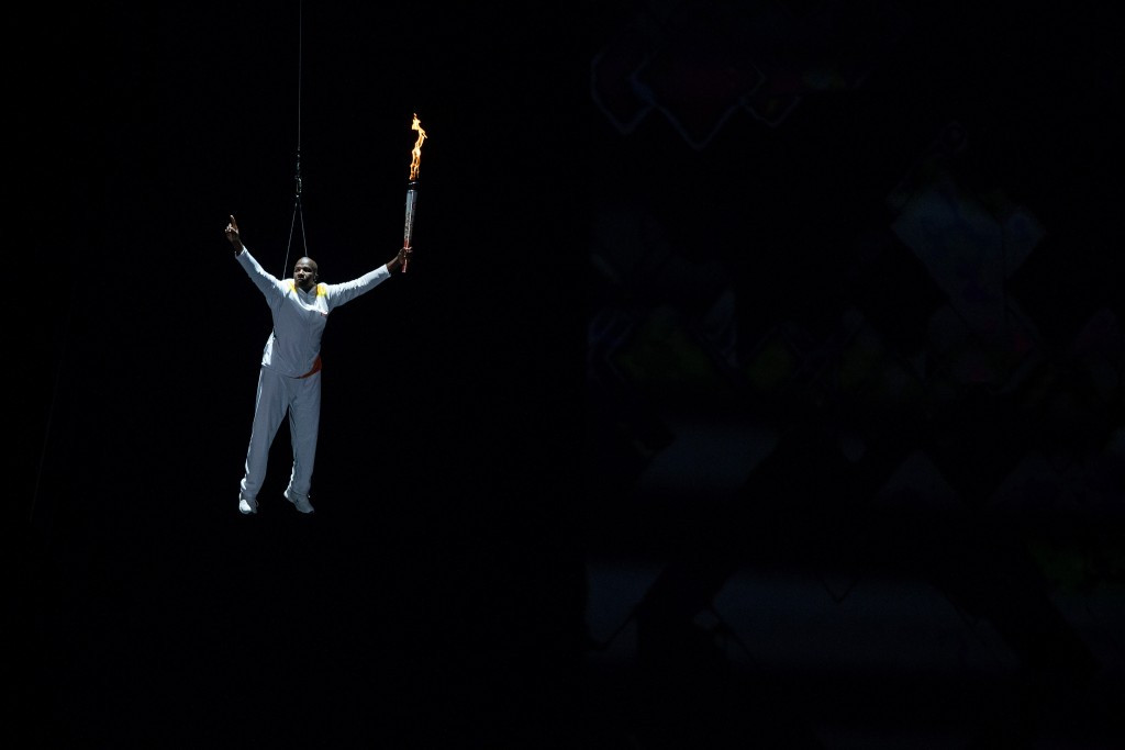 Donovan Bailey is lowered into the stadium with the Pan American Games Torch ©Getty Images