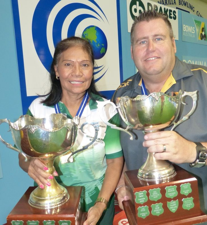 Carmen Anderson, left, and Jeremy Henry pictured with their World Cup titles last year ©World Bowls