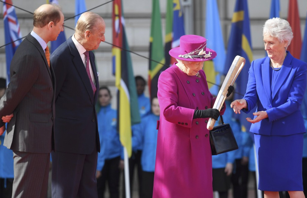Queen Elizabeth II holds the baton which has started its journey to Gold Coast for the 2018 Commonwealth Games ©Getty Images