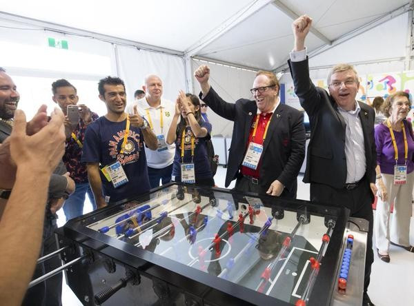 IOC President Thomas Bach (right) and Canadian Olympic Committee counterpart Marcel Aubut enjoying a game of table football in the Athletes' Village  ©Getty Images