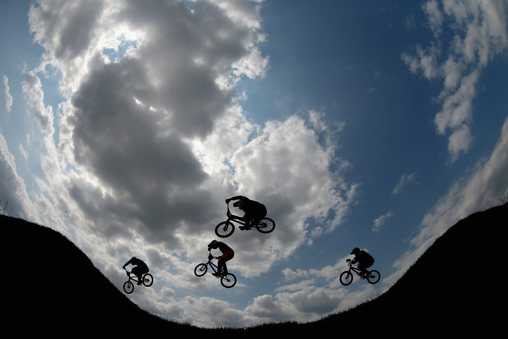 Riders fly over a jump during the men's BMX cycling competition ©Getty Images