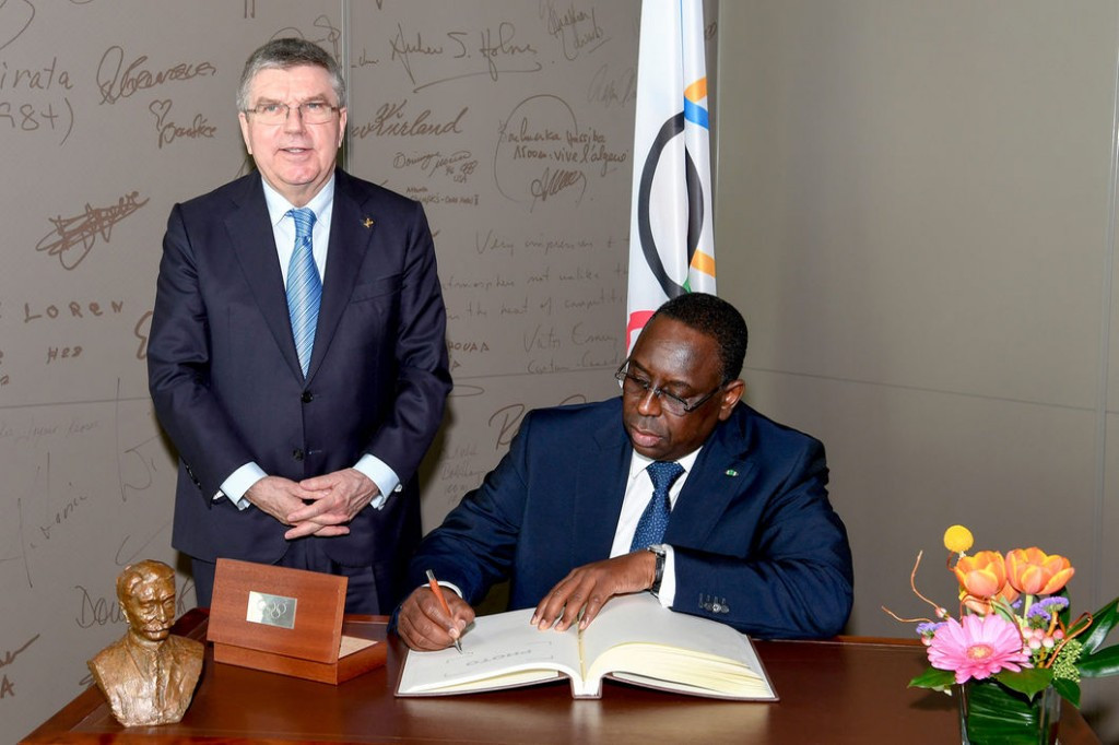 Macky Sall, right, pictured signing the IOC's 
