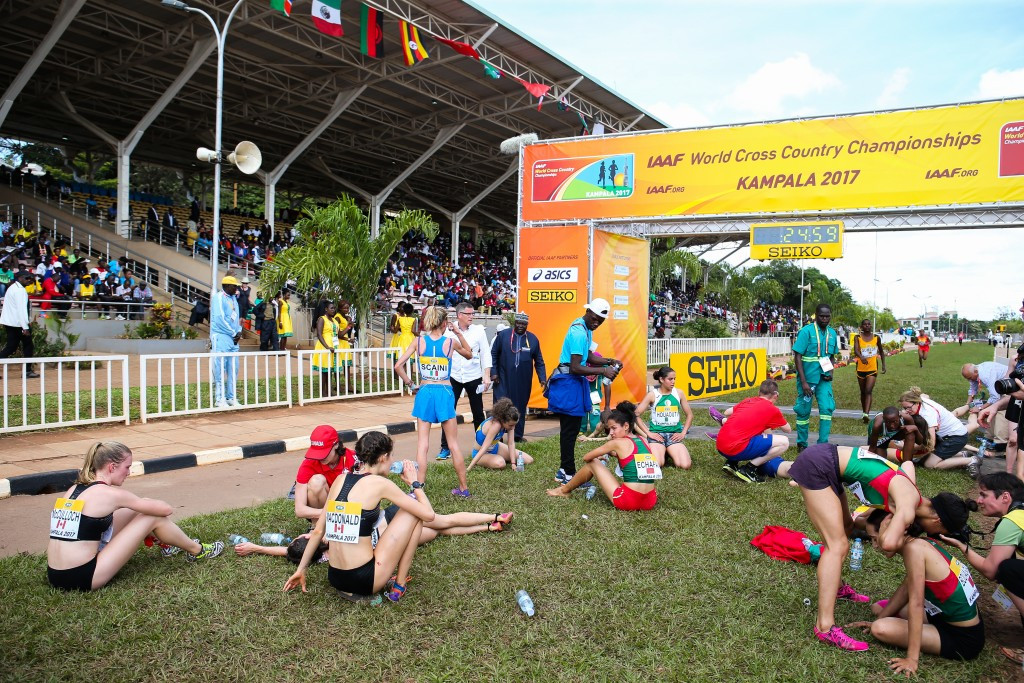 Exhausted athletes collapse after the finish line of the junior women's race at this year's World Cross Country Championships in Kamapla in Uganda ©Getty Images