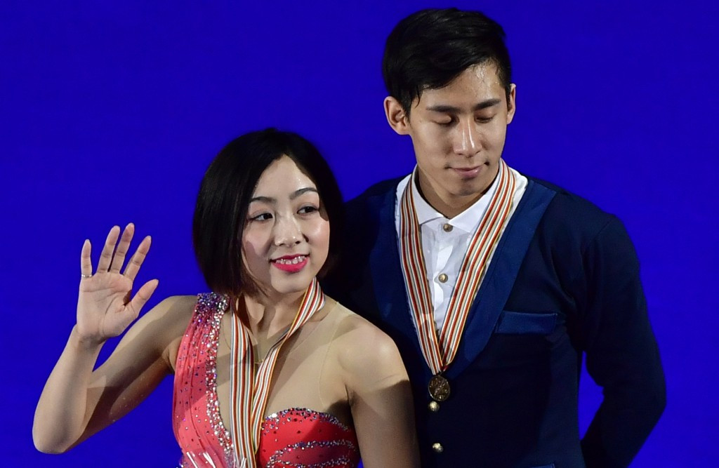 Sui and Han survive fall to win pairs skating world title