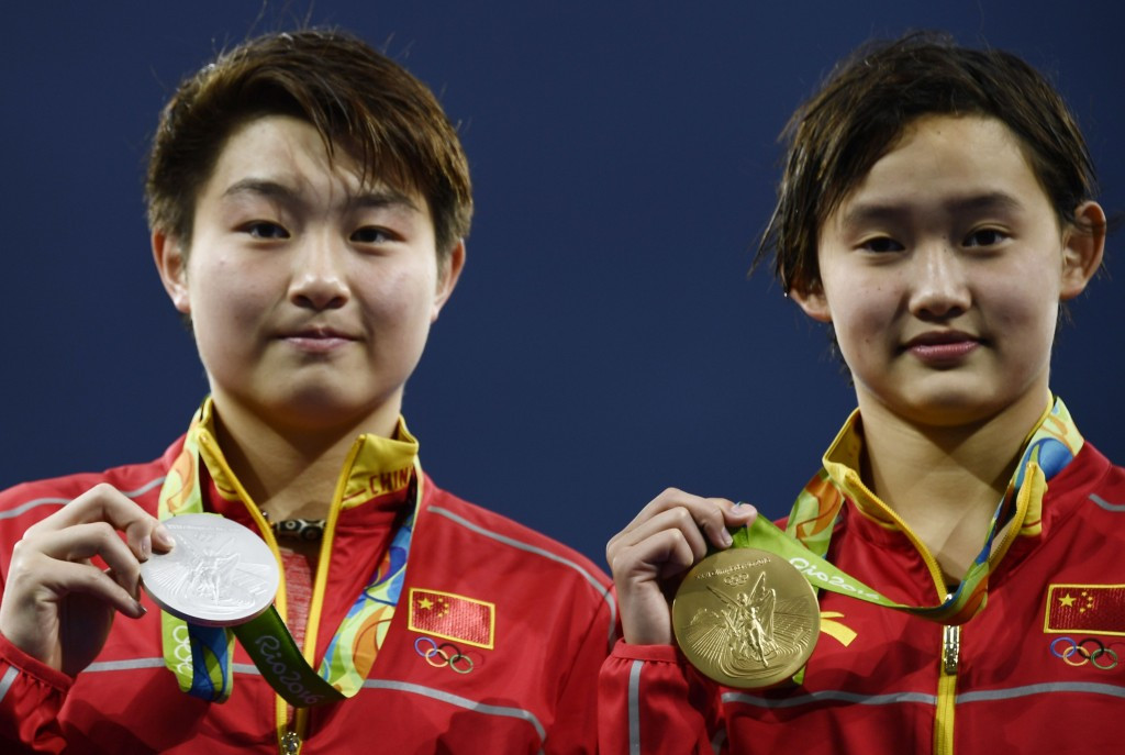 Ren Qian, right, and Si Yajie pictured celebrating with Olympic medals at Rio 2016 ©Getty Images