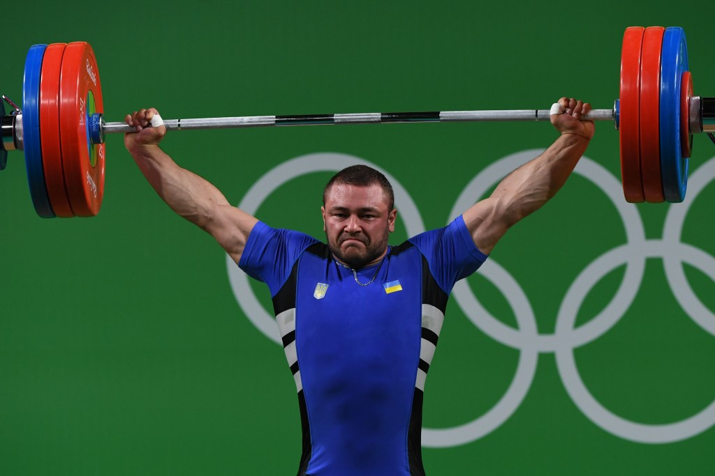 Matsokha Mykhailo, the coach of Ukraine's Dmytro Chumak, pictured, has been given a life ban from weightlifting for 