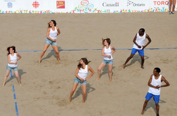 Cheerleaders entertain the crowds on the first day of beach volleyball action ©Getty Images