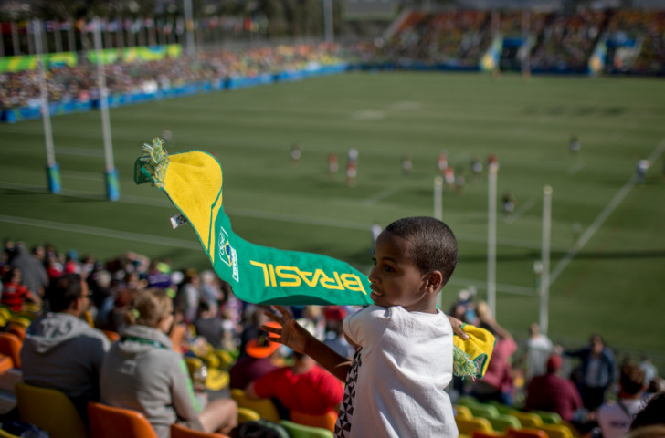 Tiago Porfirio Afonso, one of a group of children from a Rio favela given free tickets to the Olympic rugby sevens last summer, shows his support for the home team ©Getty Images