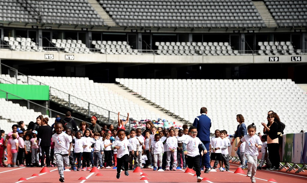 Children run at the Stade de France as they await the arrival of IOC inspectors ©Getty Images