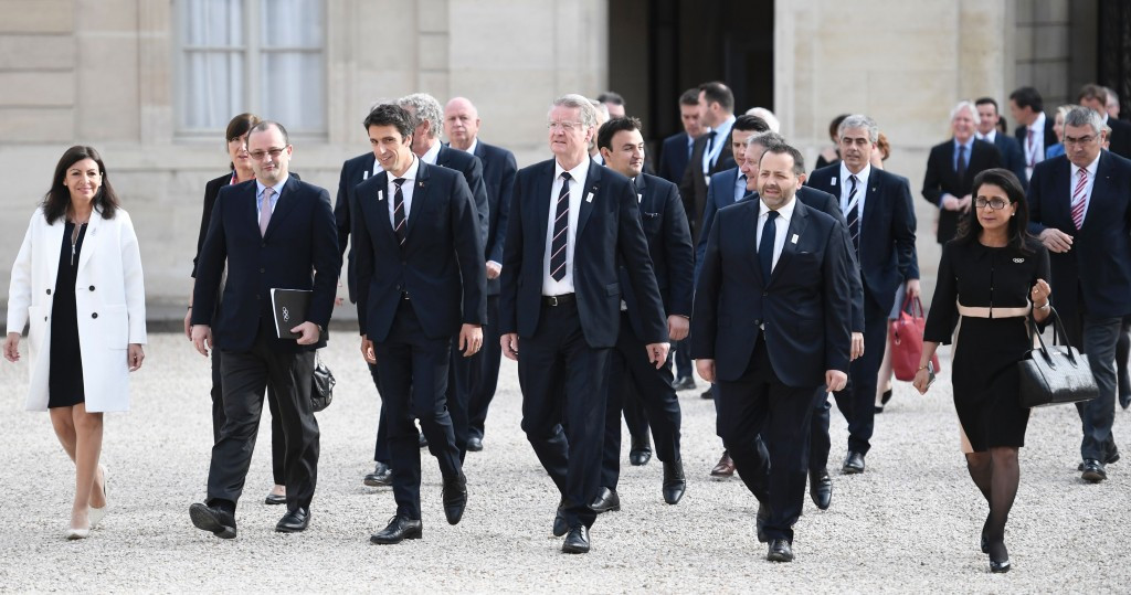 Paris 2024 and IOC officials walk to meet with Emmanuel Macron ©Getty Images