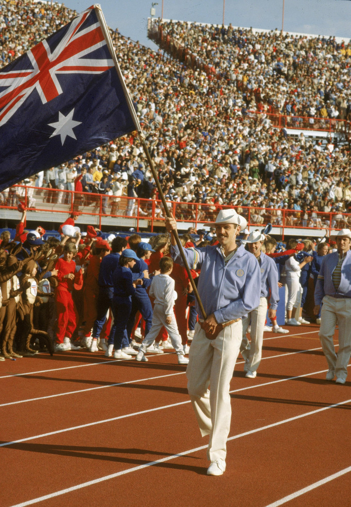 Sprinter Rick Mitchell carrying the Australian flag at the Brisbane 1982 Opening Ceremony ©Getty Images