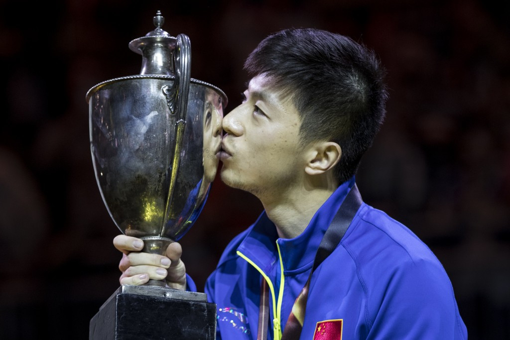 Ma Long kisses the men's singles trophy after his epic victory ©Getty Images