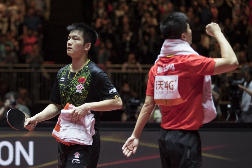 Ma Long, right, and Fan Zhendong cut contrasting figures at the end of the men's singles final ©Getty Images