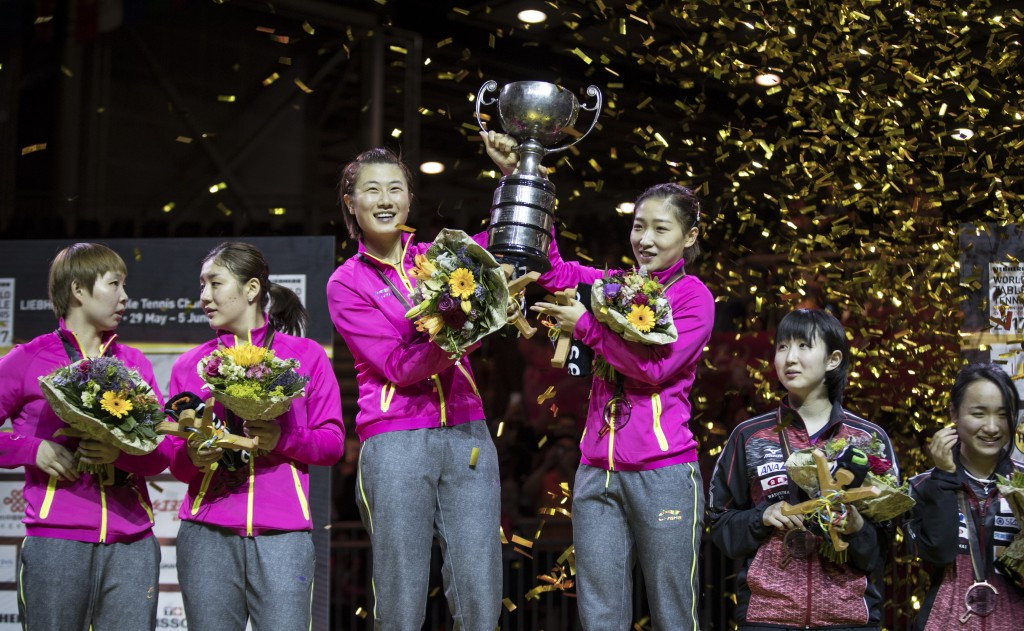 Ding Ning and Liu Shiwen lift aloft the women's doubles trophy ©Getty Images