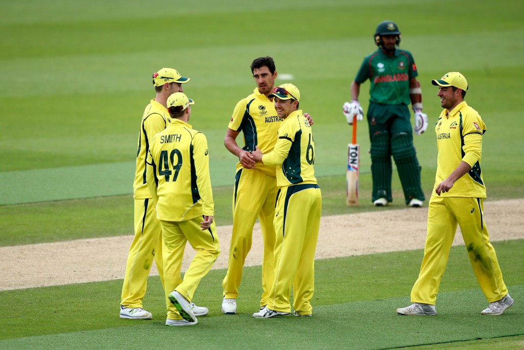 Mitchell Starc is congratulated by his team-mates after picking up one of his four wickets ©Getty Images