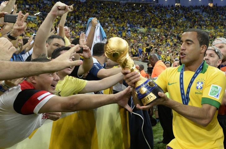 Lucas shows the FIFA Confederations Cup trophy to home fans in the Maracana Stadium after Brazil's third consecutive victory in the competition in 2013 - but on each occasion they failed to make the following year's World Cup final ©Getty Images