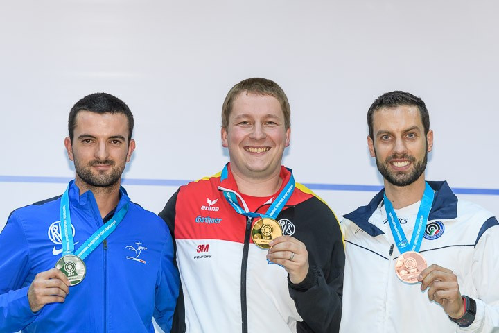 Christian Reitz, centre, equalled the 25 metre rapid fire pistol world record as he won an 11th ISSF World Cup gold ©ISSF