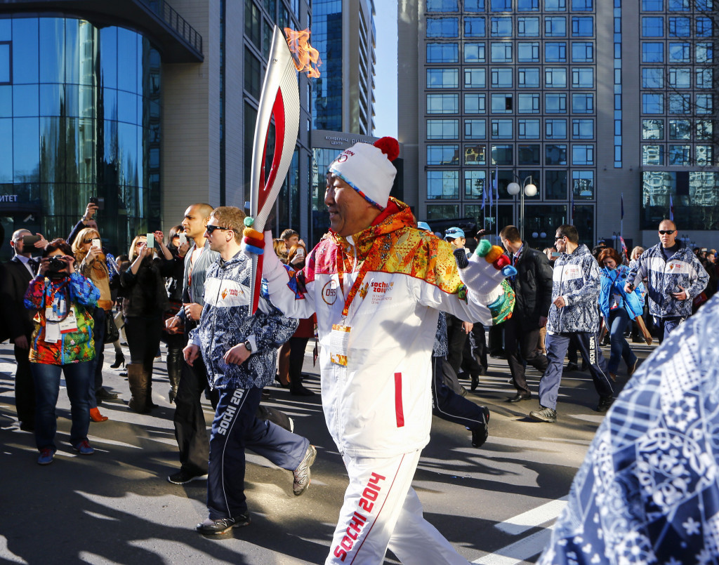 Ban Ki-moon carrying the Olympic Torch before Sochi 2014 ©Getty Images