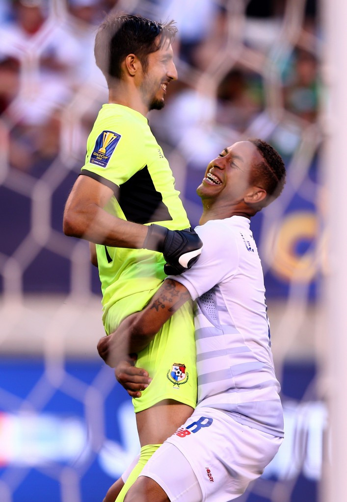 Panama goalkeeper Jaime Penedo is hoisted high by team-mate Gabriel Torres after his save in the penalty shoot-out against Trinidad and Tobago ensured they won their Gold Cup quarter-final match in East Rutherford