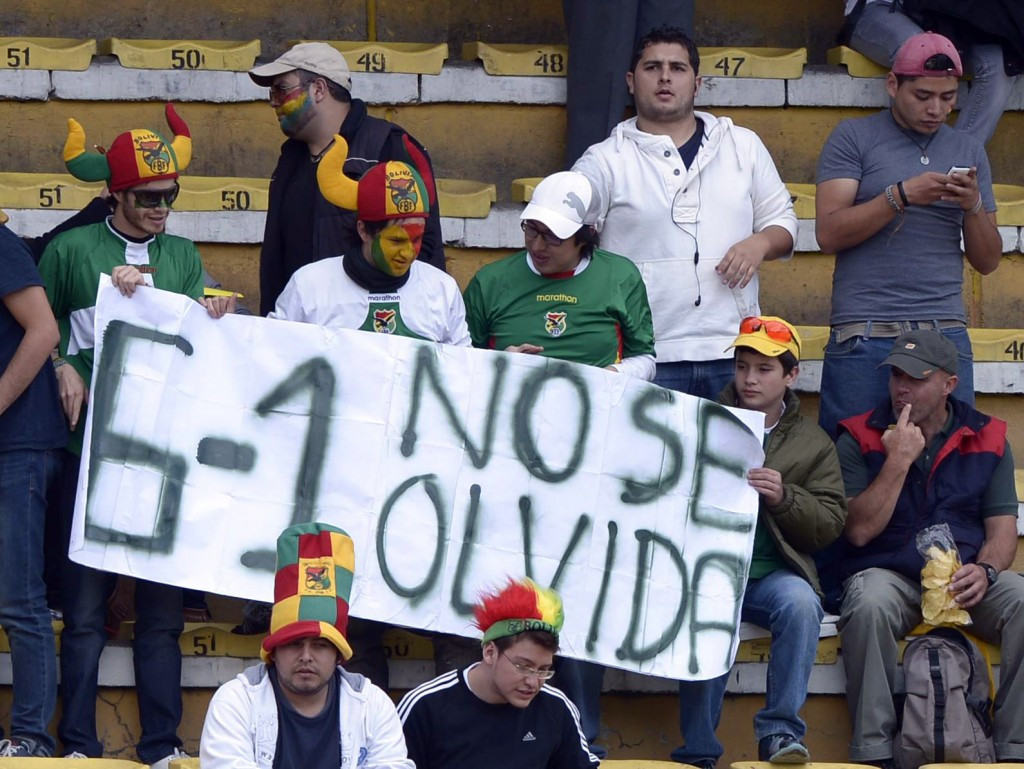 Bolivia fans hold up a sign saying 
