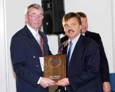 Nils Nilsson, left, being inducted into the IIHF Hall of Fame in 2002 by President René Fasel ©IIHF  