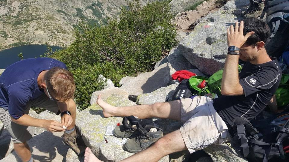 My friend had the unfortunate job of helping treat my blisters on the side of a mountain ©Daniel Woodgate