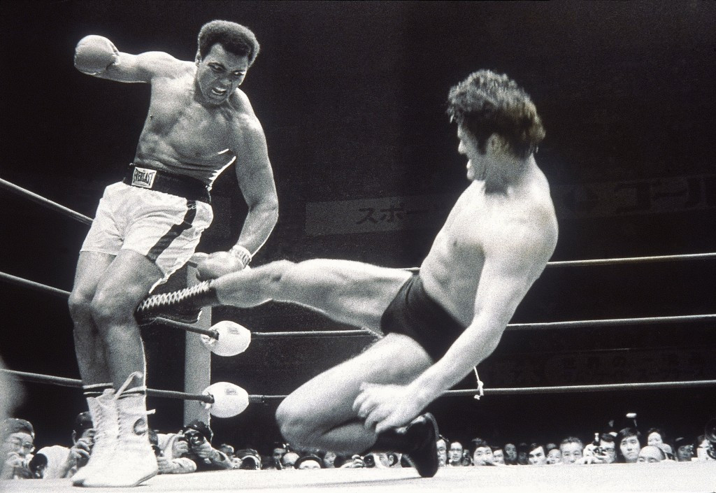 Antonio Inoki sends another kick to Muhammad Ali's leg during their infamous 