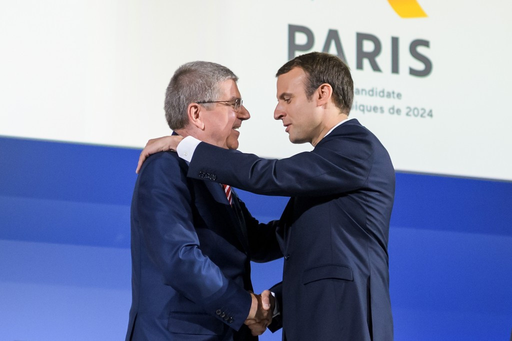 French President Emmanuel Macron, right, embraces IOC counterpart Thomas Bach ©Getty Images