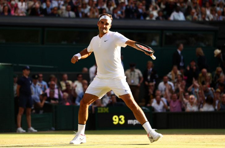 Roger Federer celebrates becoming the only one of the 