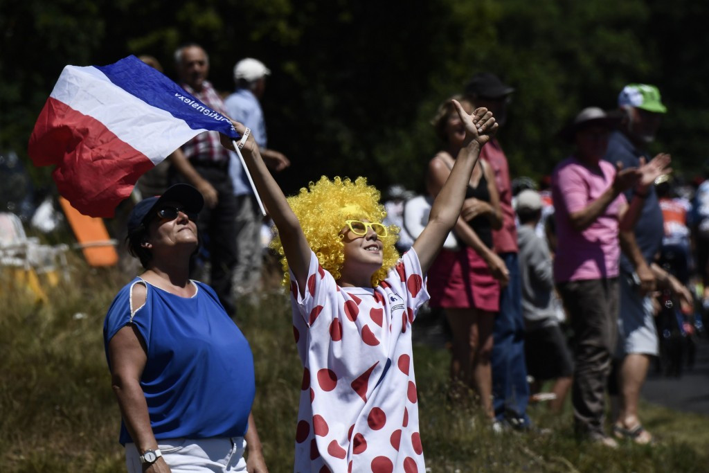 A supporter holds a French flag during the 165km stage ©Getty Images